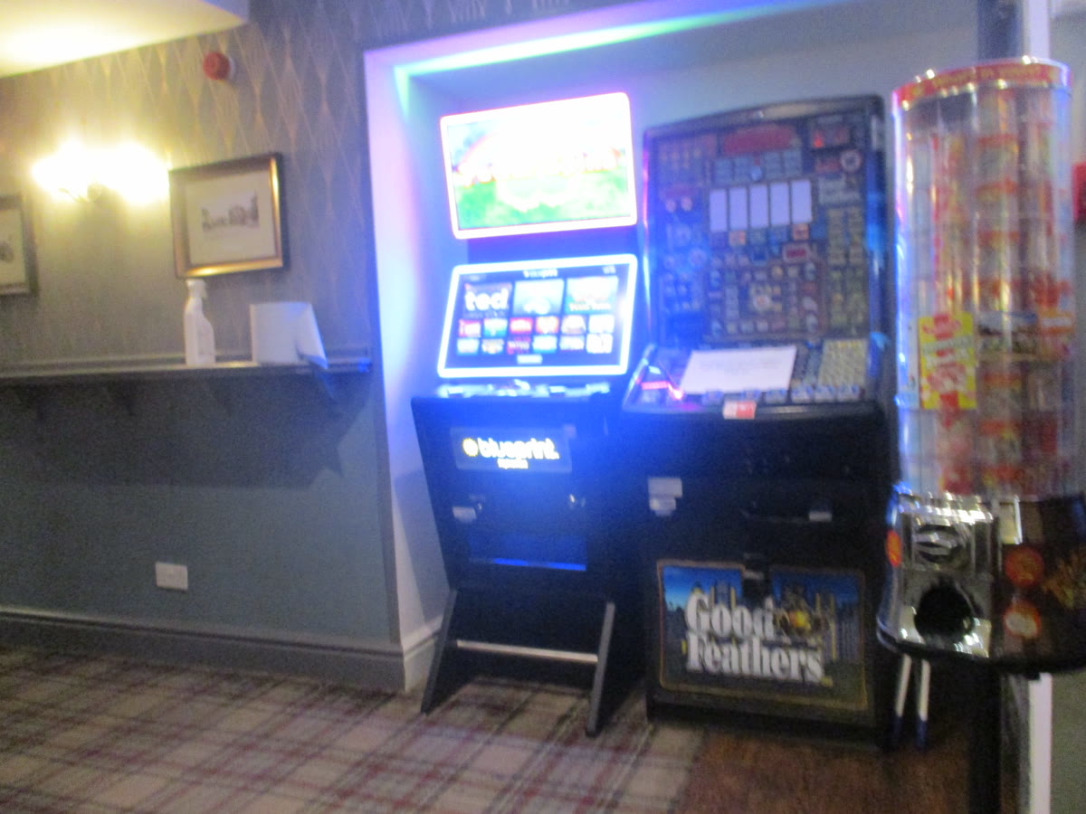 A couple of pokie machines in the corner of the bar